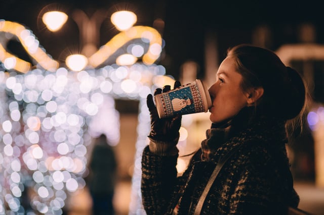Young employee takes a break during the holidays and sips a warm beverage Young employee takes a break during the holidays and sips a warm beverage